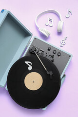 Record player with vinyl disk, headphones and note signs on lilac background