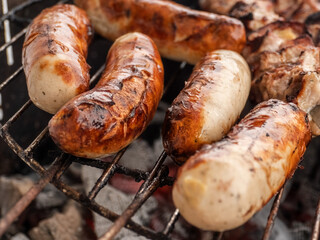 Original German Bratwurst sausage sizzling on the grill