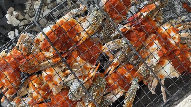 Top view fresh crabs cooked on bbq grill using coil. Gurman dish preparation. Oman
