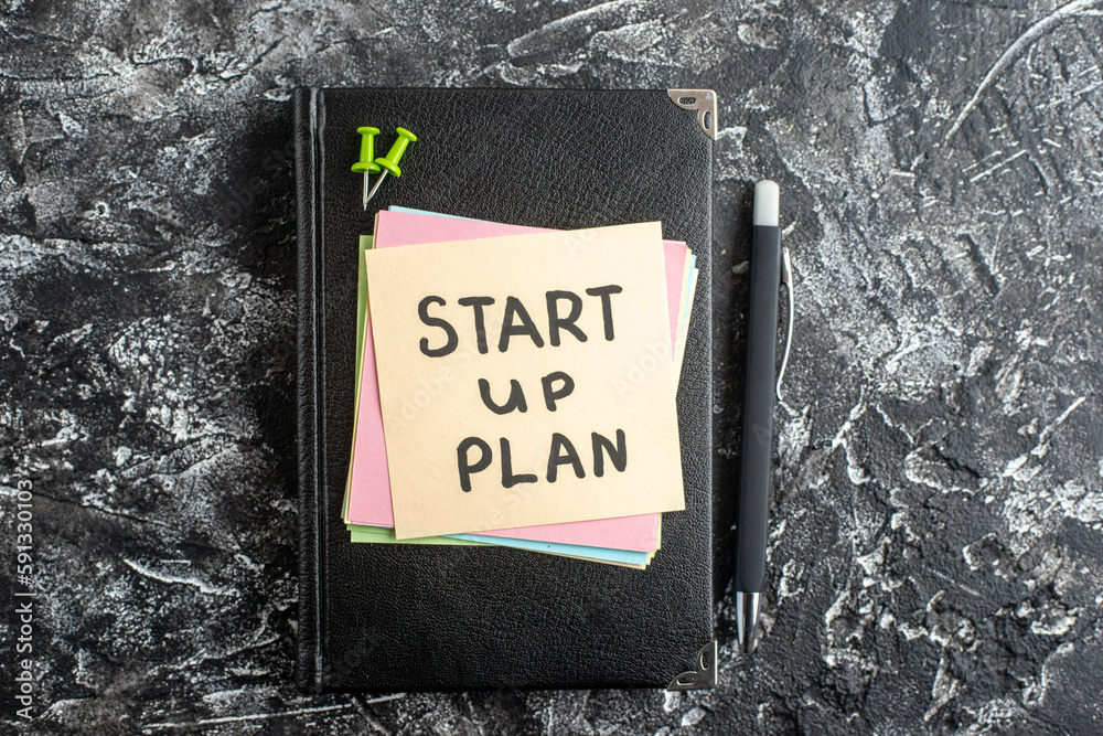 Wall mural top view start up plan note on sticker with copybook on gray background lesson student note notepad 