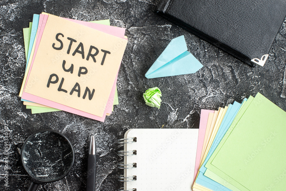 Wall mural top view start up plan note on sticker with copybook on gray background lesson student notepad note 