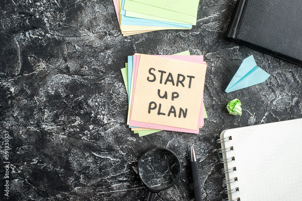 Wall mural top view start up plan note on sticker with copybook on gray background lesson student notepad note 