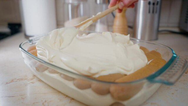 Putting Mascarpone Cream Top Of Tiramisu. The Process Of Making Italian Tiramisu Cake.
