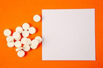 top view white pills on orange background lab disease drug covid- health pandemic science virus vaccine