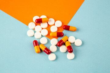 top view white pills on orange-blue background lab disease drug covid- health pandemic science virus
