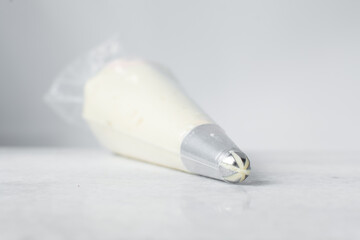 Buttercream in a piping bag, American buttercream in a piping bag for icing cake, frosting for...