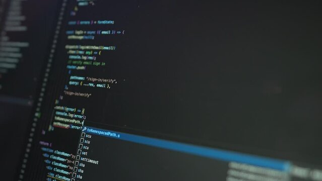 Coding Programmer's Script Typing On Computer Monitor. closeup