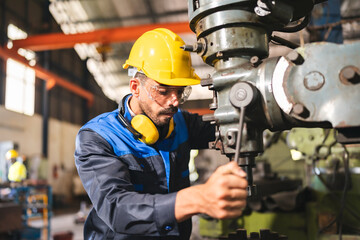 professional technician engineer with safety helmet hard hat working in industrial manufacturing...