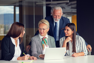 Mature businessman leader mentor talking to diverse colleagues team listening to caucasian ceo.