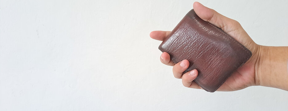 Man hand hold the wallet isolated on white background with copy space for text