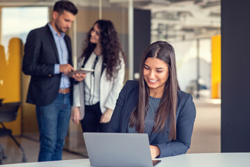 Couple of busy colleagues working together in modern office