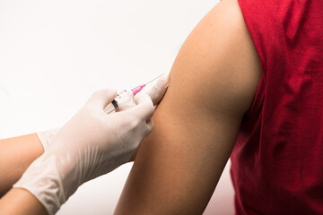 Close up doctor's hand injecting for vaccination in the shoulder man patien on white background.Vaccine for protection covid-19 (Corona virus) infection.Vaccination for influenza treatment.