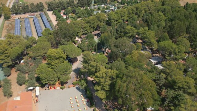 ITALY, Solar Panel Rows and Green Trees, Tuscany Eco Camping Village, Drone