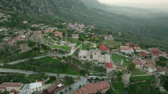 Aerial shows surroundings of Kruja, Albania with Castle in Foreground