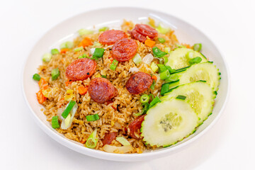 Fried rice with Chinese pork sausage , eggs , scallions and cucumbers on white background.