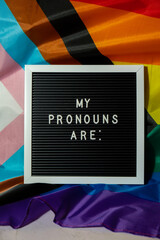 MY PRONOUNS ARE text Neo pronouns concept on Rainbow flag background gender pronouns. Non-binary people rights transgenders. Lgbtq community support assume my gender, respect pronouns tolerance equal - obrazy, fototapety, plakaty
