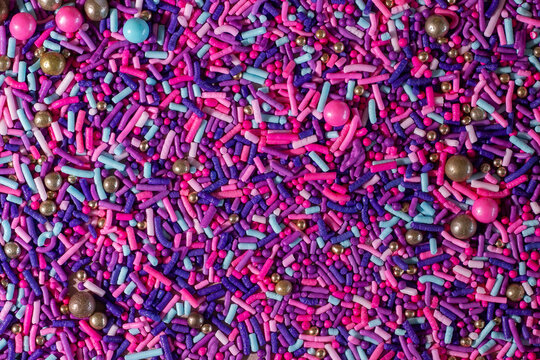 Pink, purple, and blue sprinkle texture close up