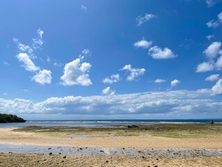 Beautiful beach with a view of the coastline blue sky and white clouds