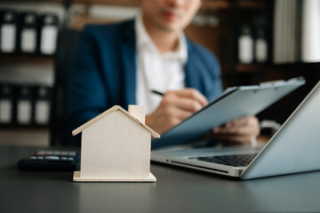  Signing a contract. Client and broker agent, lease agreement, successful deal and  Young business sitting at the desk in office .