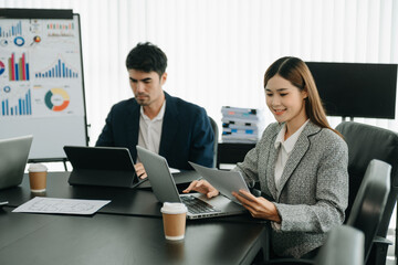  Young Asian business creative team are brainstorming planning discussing while sitting in creative business discussing work in the office.