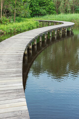 Fototapeta premium Wooden trail over pond in Hong Kong wetland park