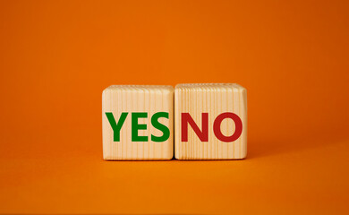 Yes vs No symbol. Wooden cubes with words YES and No. Beautiful orange background. Business concept. Copy space.