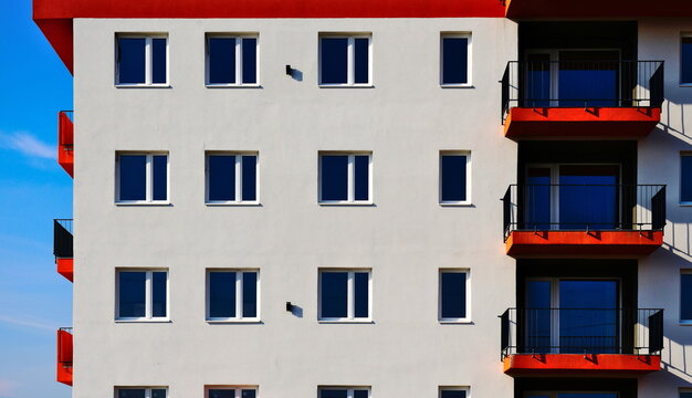 Red Textured Stucco Balcony Slabs. Steel Picket Railing. Perspective View. Residential Building Elevation. White Stucco Exterior Wall. Modern Architecture. Apartment Building. Elevation Closeup Detail