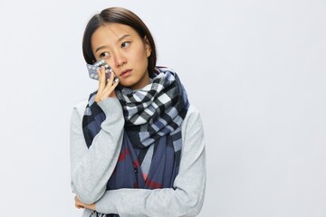 Asian woman headache cold flu holding medicine and pills with fever is sick from the virus on a white background, copy space