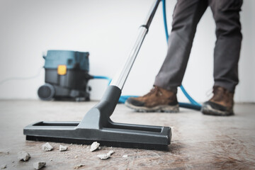Professional construction cleaning service with powerful vacuum cleaner. - obrazy, fototapety, plakaty