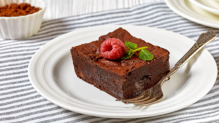 Fototapeta na wymiar chocolate brownies with fresh raspberry and mint
