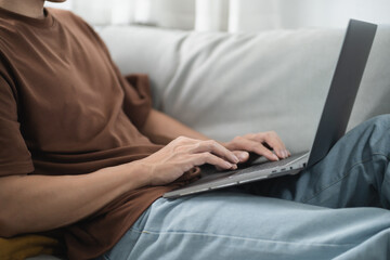 Fototapeta premium Man work from home. work online on laptop. Asian businessman working online business concept with social distancing laptop online meeting.
