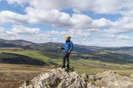 hiker man who has reached triumphant mountain top © Cavan