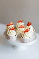 cream cupcakes with fresh strawberries freshly prepared by pastry chef