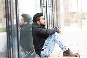 Young Man sitting outside on the bottom