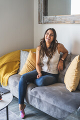 Obraz premium Beautiful Woman Working From Home On The Sofa