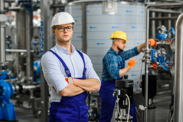 Portrait of a young factory engineer posing in the shop.