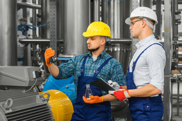 Two engineers consider the results of purification of dirty industrial water. Wastewater treatment...