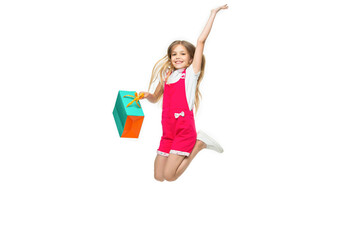 happy teen girl jumping after shopping in studio. teen girl jumping after shopping