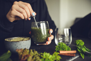Making healthy green cocktail, in the kitchen