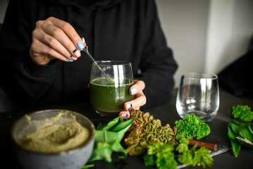 Making healthy green cocktail, in the kitchen