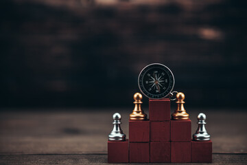 compass and chess piece on cube wood for ideas, challenge, leadership, strategy, business, success or abstract. © Charnchai saeheng