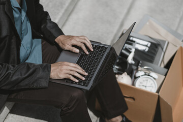 Employees fired or resigned from the company use laptop to find a job, schedule an interview..Unemployed, hiring job, quitting job concept.