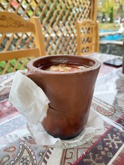 Azerbaijani Sheki piti soup prepared with mutton, tail fat, chickpeas, potato, onions, dried alycha and saffron and cooked in a clay pot - 591390196