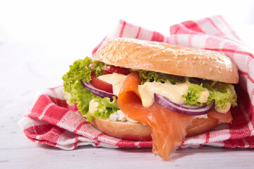 hamburger with lettuce, onion, salmon fillet and sauce- vegetarian burger