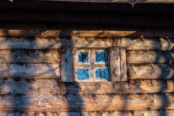 fragments of an old wooden hut decorated with birds