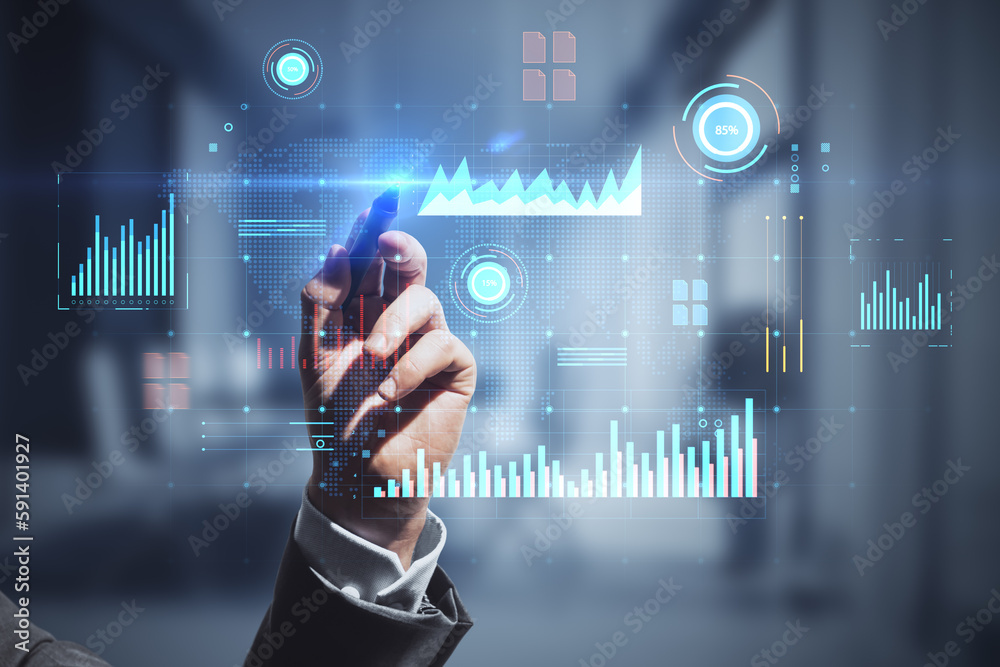 Poster close up of man hand with pen pointing at glowing digital business interface with charts on blurry o