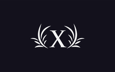 Obraz premium Golden laurel wreath leaf logo design vector with the letters and alphabets and bamboo leaf