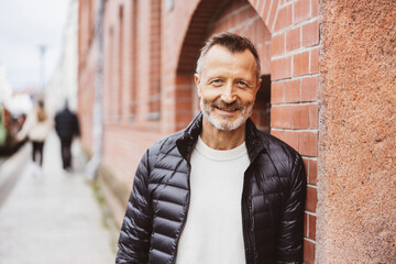 Confident Middle-Aged Man Smiling in Urban Setting
