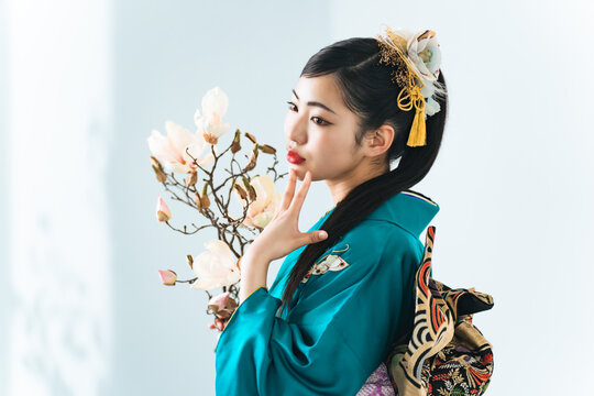 Portrait of young Asian girl wearing kimono. Japanese traditional ceremony dress.