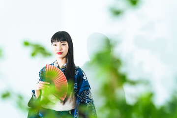 Portrait of young Asian girl wearing Yukata. Japanese traditional summer dress.